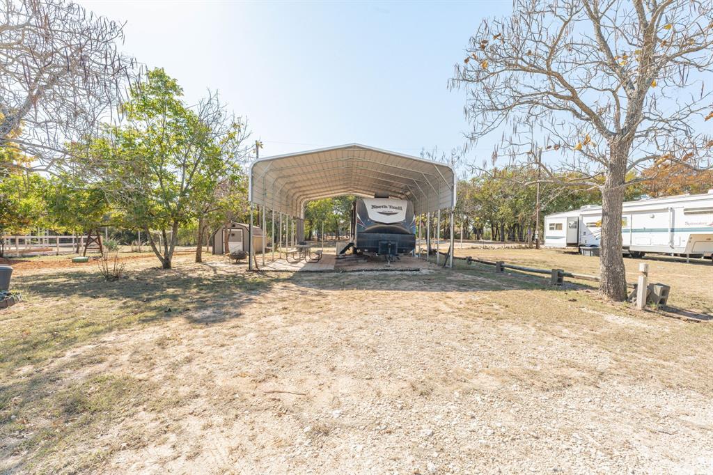 357 Discovery Bay Road Comanche, TX 76442 - Photo 2 of 32 a house with trees in front of it