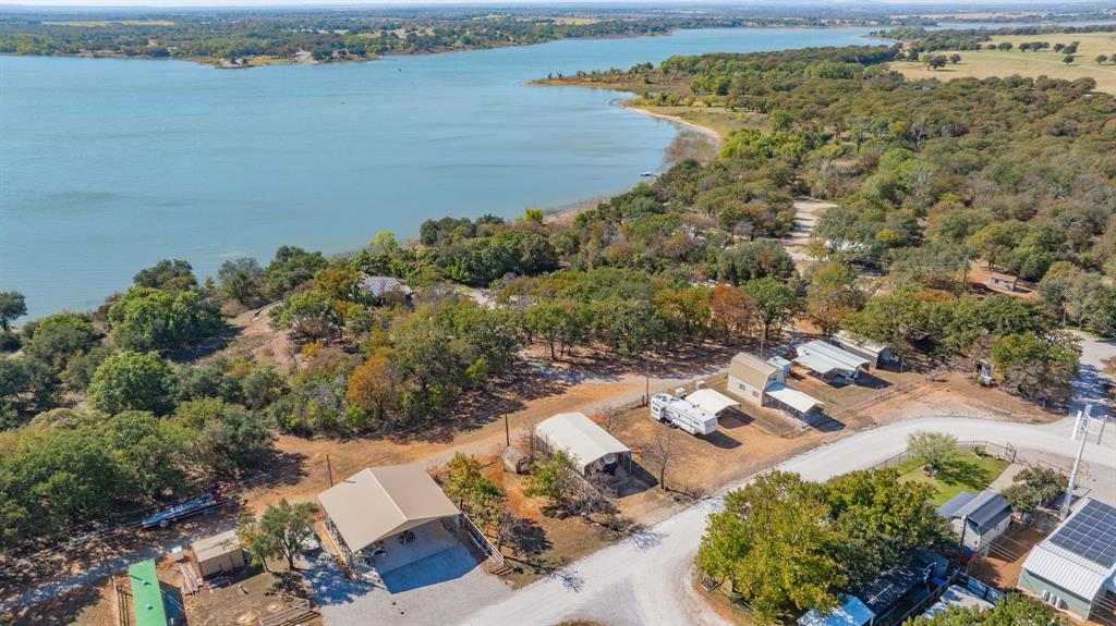 357 Discovery Bay Road Comanche, TX 76442 - Photo 21 of 32 an aerial view of a house with a lake view