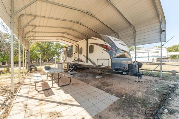 a view of a chairs and table in backyard
