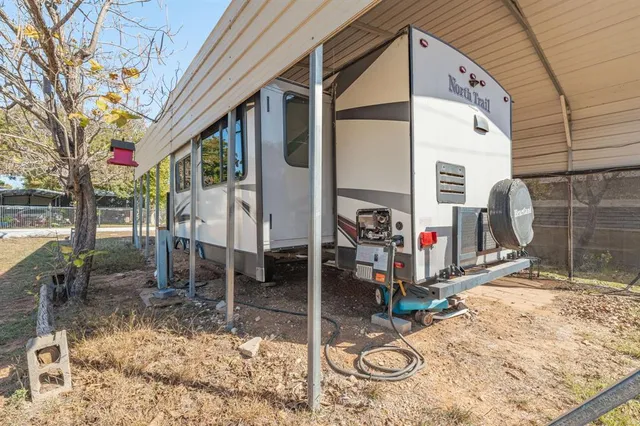 a view of a patio with table and chairs a barbeque grill with floor to ceiling window