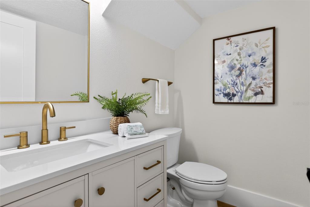 1815 Seneca Boulevard Winter Springs, FL 32708 - Photo 16 of 32 a bathroom with a toilet a sink and a mirror