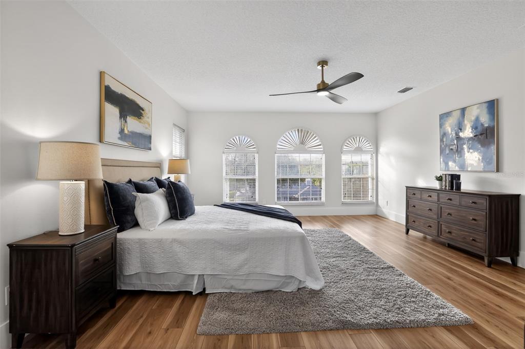 1815 Seneca Boulevard Winter Springs, FL 32708 - Photo 18 of 32 a bedroom with a large bed and wooden floor