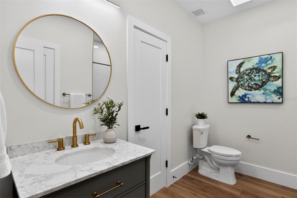 1815 Seneca Boulevard Winter Springs, FL 32708 - Photo 27 of 32 a bathroom with a granite countertop sink a toilet and a mirror