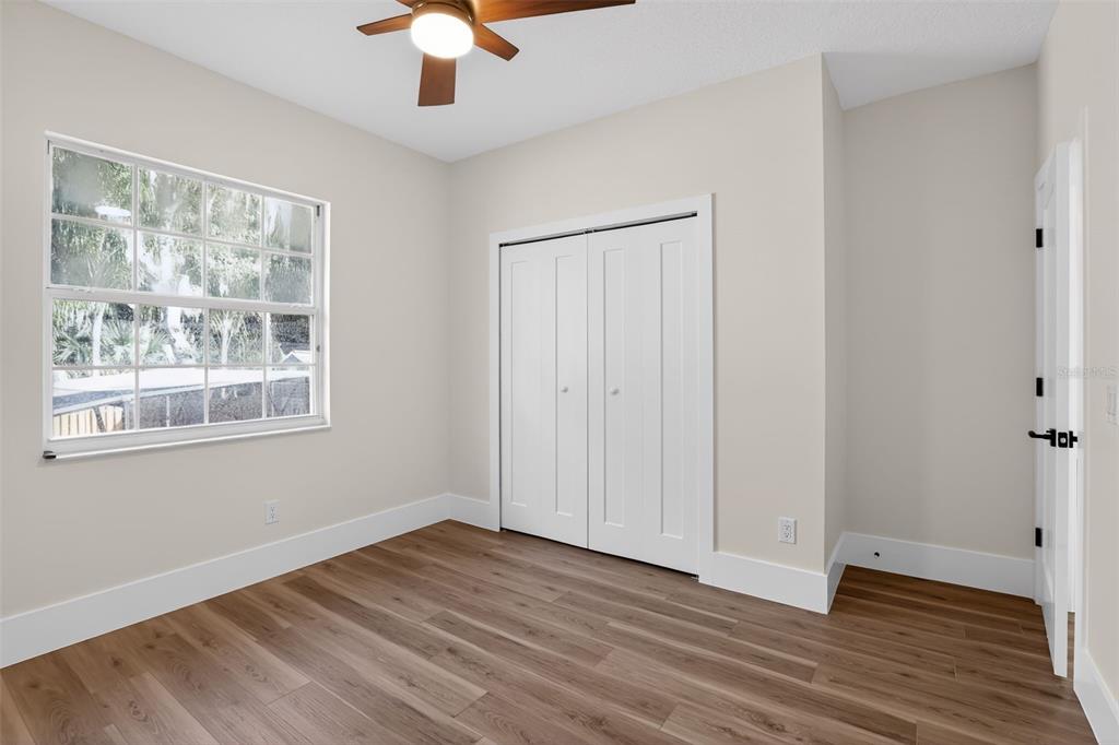 1815 Seneca Boulevard Winter Springs, FL 32708 - Photo 28 of 32 an empty room with wooden floor chandelier fan and windows