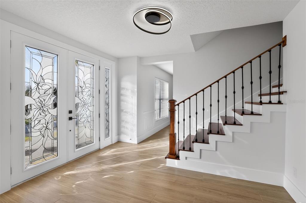 1815 Seneca Boulevard Winter Springs, FL 32708 - Photo 6 of 32 a view of entryway with wooden floor and stairs