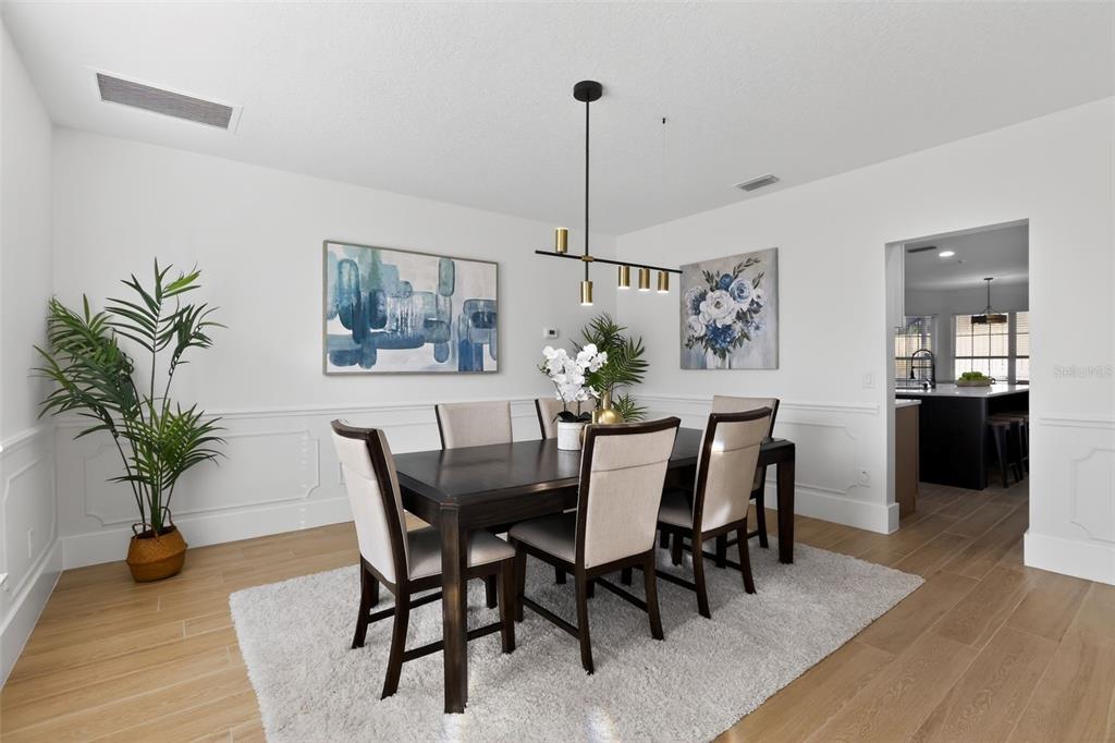 1815 Seneca Boulevard Winter Springs, FL 32708 - Photo 8 of 32 a view of a dining room with furniture and wooden floor