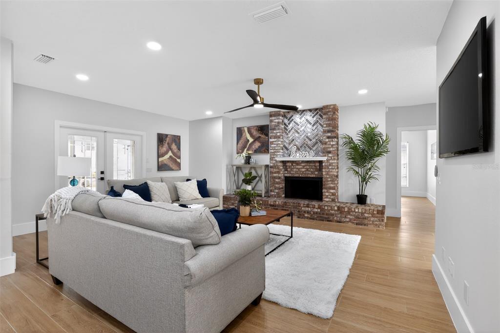 1815 Seneca Boulevard Winter Springs, FL 32708 - Photo 10 of 32 a living room with furniture a fireplace and a flat screen tv