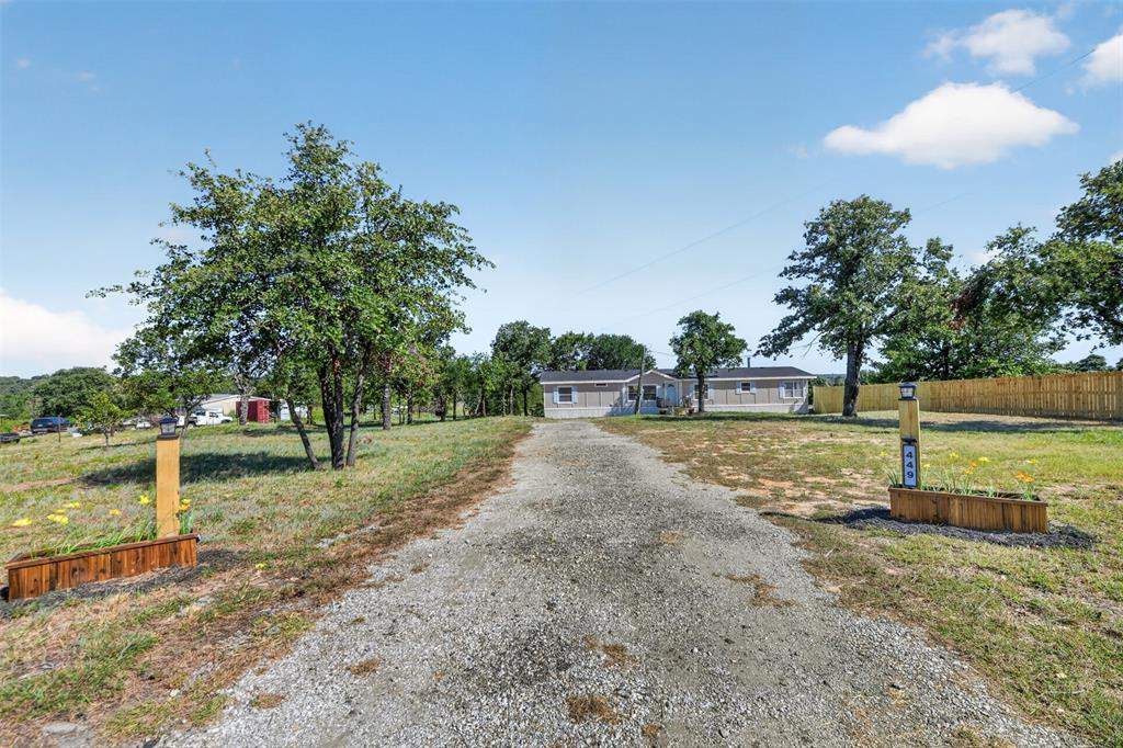 449 Big Salty Lane Springtown, TX 76082 - Photo 2 of 25 Graveled front entry driveway with garden beds