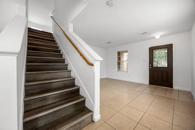a view of an entryway with wooden floor and stairs