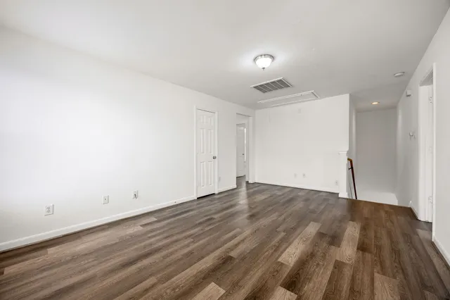an empty room with wooden floor
