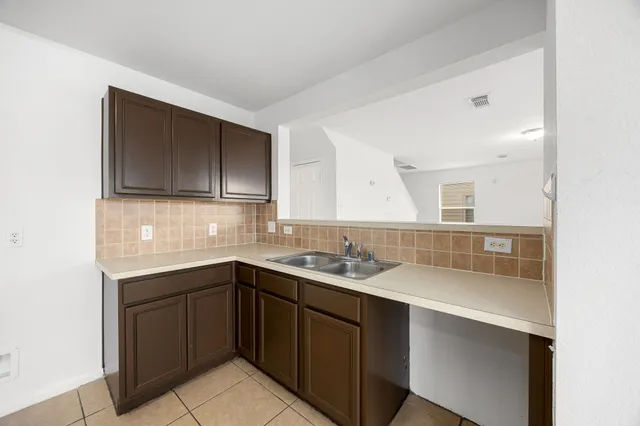 a kitchen with a sink and cabinets