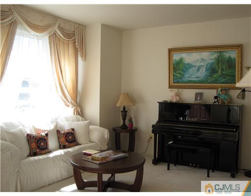 31 Lexington Road Monmouth Junction, NJ 08852 - Photo 3 of 12 a living room with a couch and a floor to ceiling window
