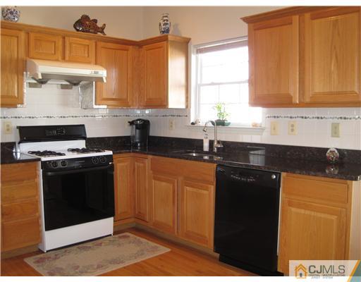 31 Lexington Road Monmouth Junction, NJ 08852 - Photo 4 of 12 a kitchen with granite countertop a sink a stove and cabinets