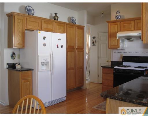 31 Lexington Road Monmouth Junction, NJ 08852 - Photo 5 of 12 a kitchen with a refrigerator and a stove