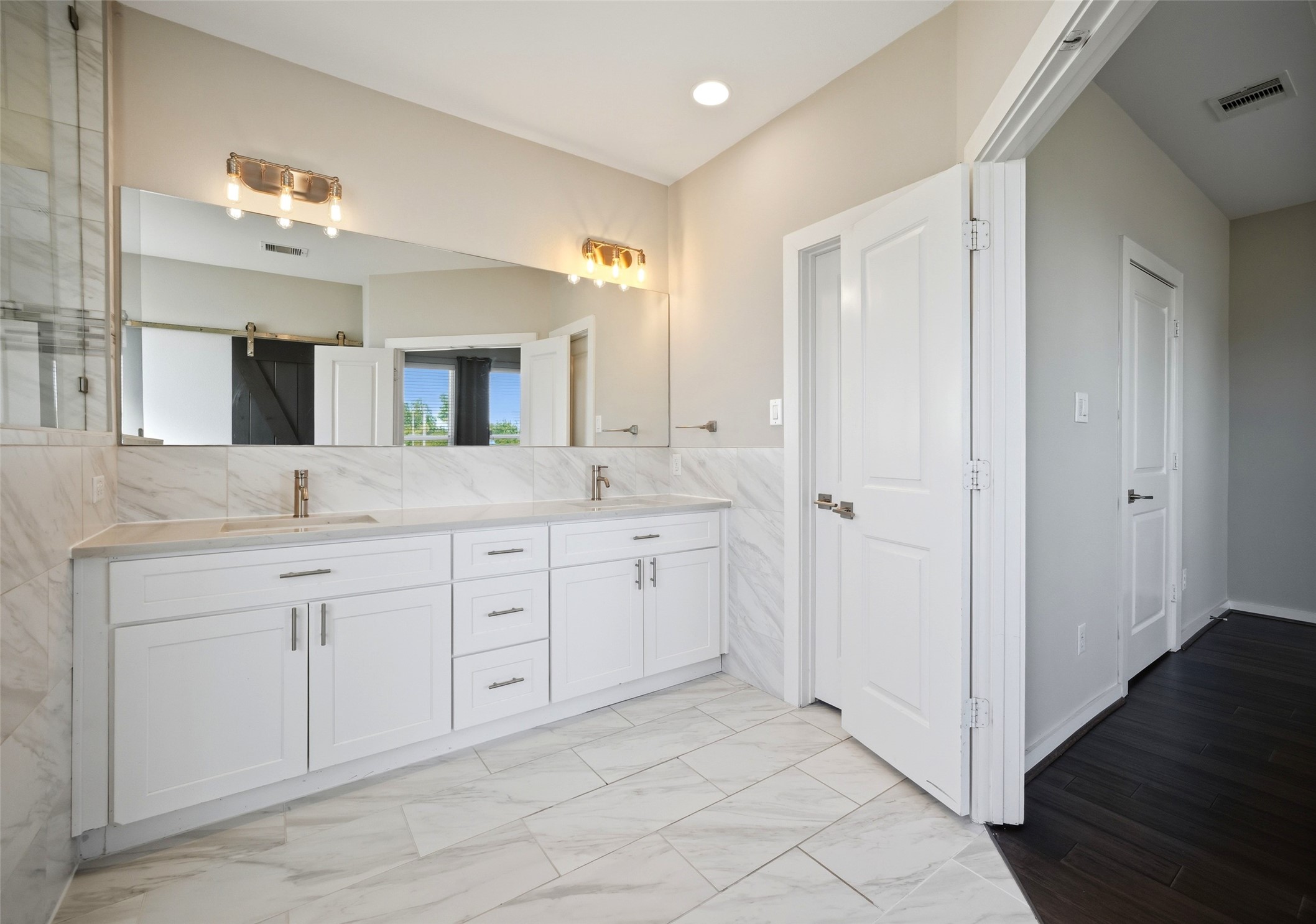 605 Dumble Street Houston, TX 77023 - Photo 27 of 44 a spacious bathroom with a granite countertop sink mirror and a