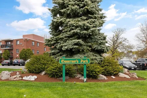 a view of outdoor space with sign board and garden