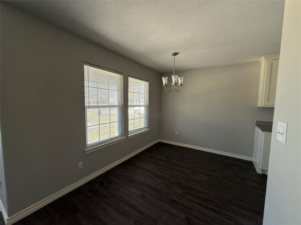 705 South Binkley Street Sherman, TX 75092 - Photo 11 of 22 an empty room with wooden floor and windows