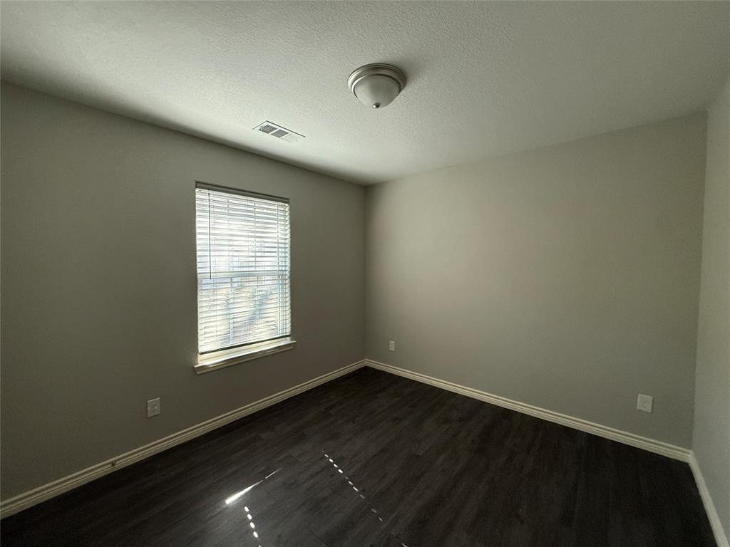 705 South Binkley Street Sherman, TX 75092 - Photo 12 of 22 an empty room with wooden floor and windows
