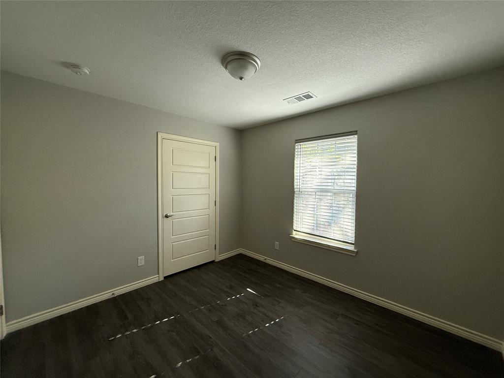 705 South Binkley Street Sherman, TX 75092 - Photo 13 of 22 an empty room with wooden floor and windows