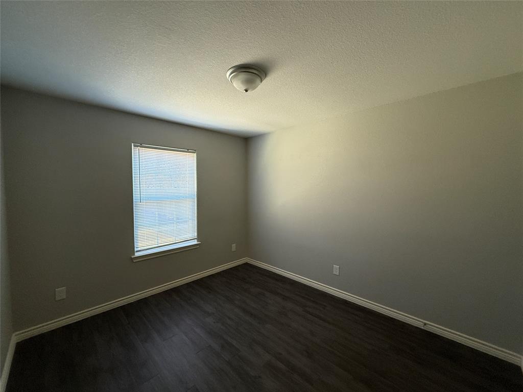 705 South Binkley Street Sherman, TX 75092 - Photo 15 of 22 an empty room with wooden floor and windows