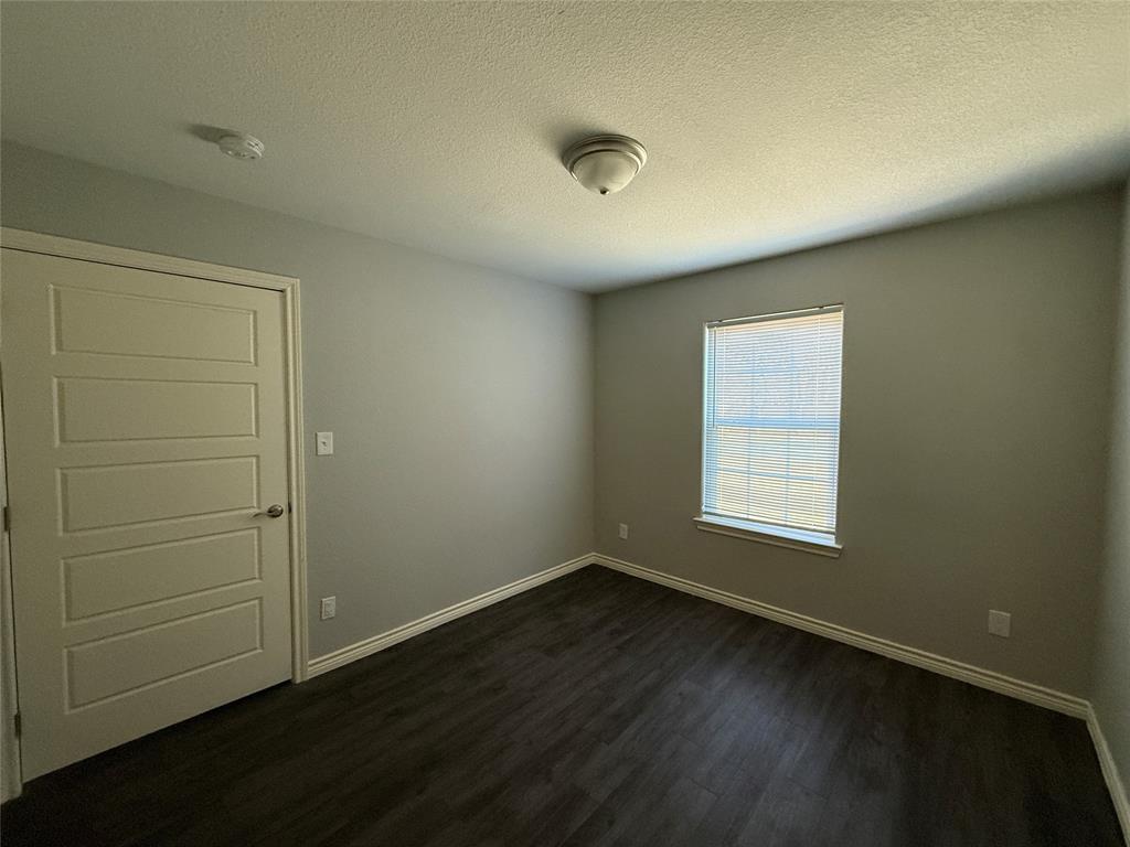 705 South Binkley Street Sherman, TX 75092 - Photo 16 of 22 an empty room with wooden floor and window