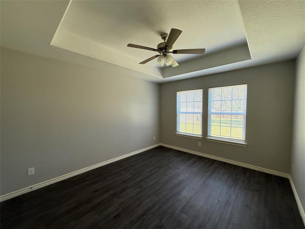 705 South Binkley Street Sherman, TX 75092 - Photo 18 of 22 a view of an empty room with wooden floor and a window