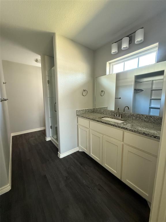705 South Binkley Street Sherman, TX 75092 - Photo 20 of 22 a bathroom with a granite countertop sink and a mirror