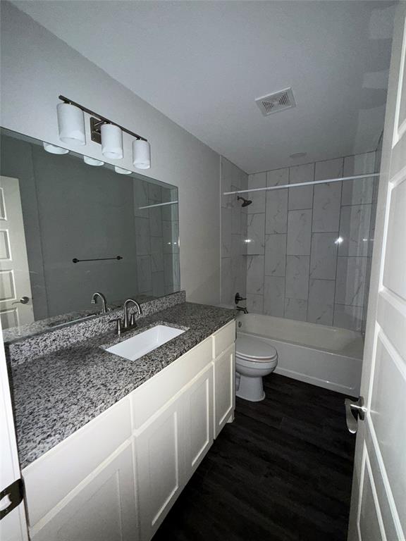 705 South Binkley Street Sherman, TX 75092 - Photo 21 of 22 a bathroom with a granite countertop sink a toilet and shower