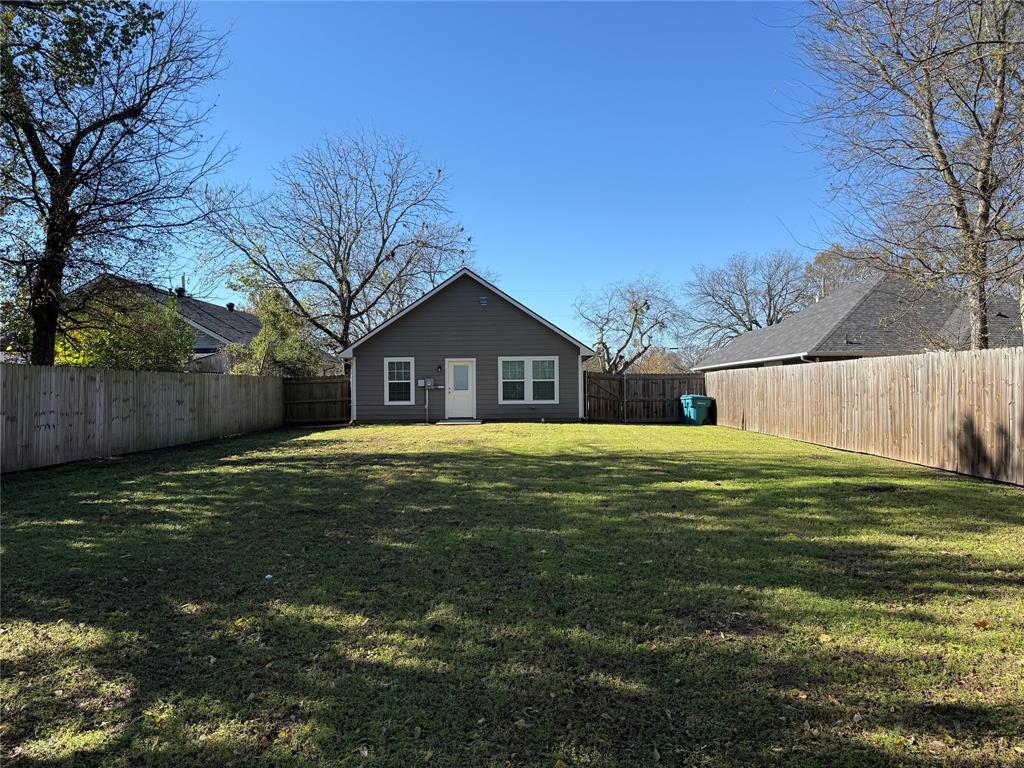 705 South Binkley Street Sherman, TX 75092 - Photo 22 of 22 a front view of a house with a yard