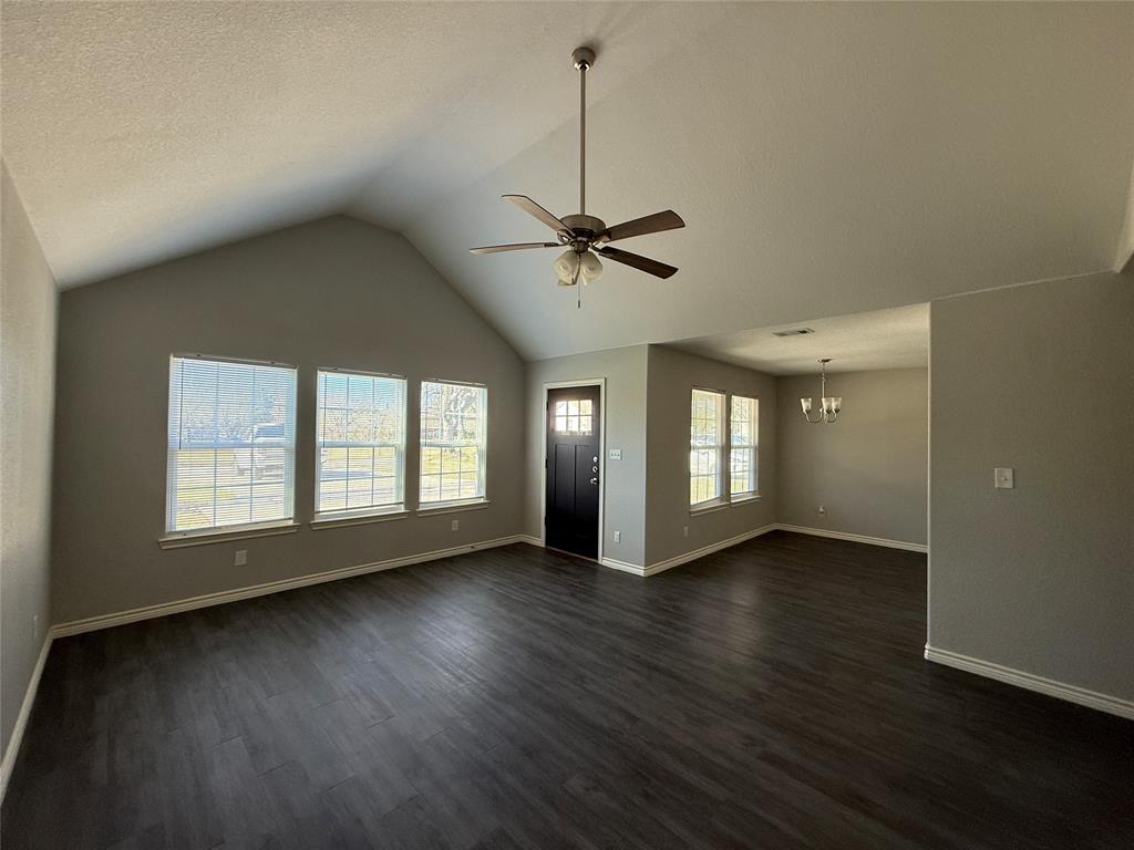 705 South Binkley Street Sherman, TX 75092 - Photo 4 of 22 a view of an empty room with a window and wooden floor