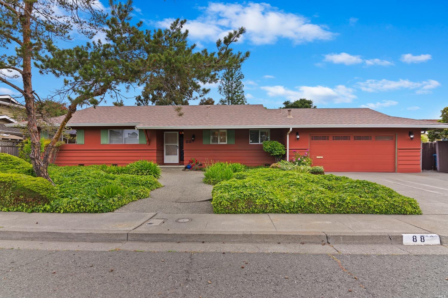 a front view of a house with a garden