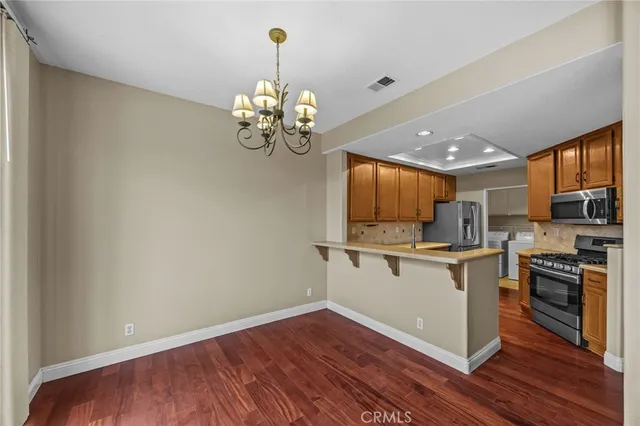 a kitchen with a sink stainless steel appliances and cabinets