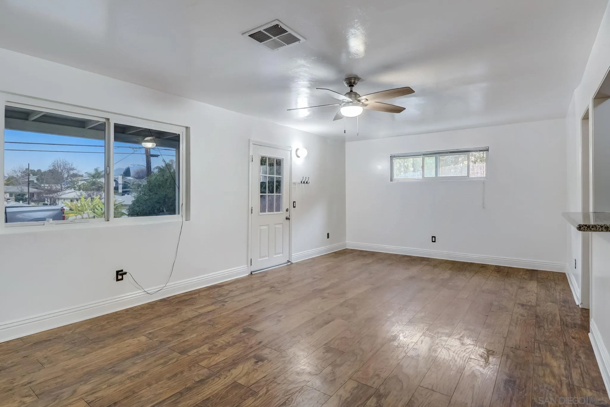 9115 Rosedale Drive Spring Valley, CA 91977 - Photo 13 of 31 a view of a room with wooden floors and ceiling fan