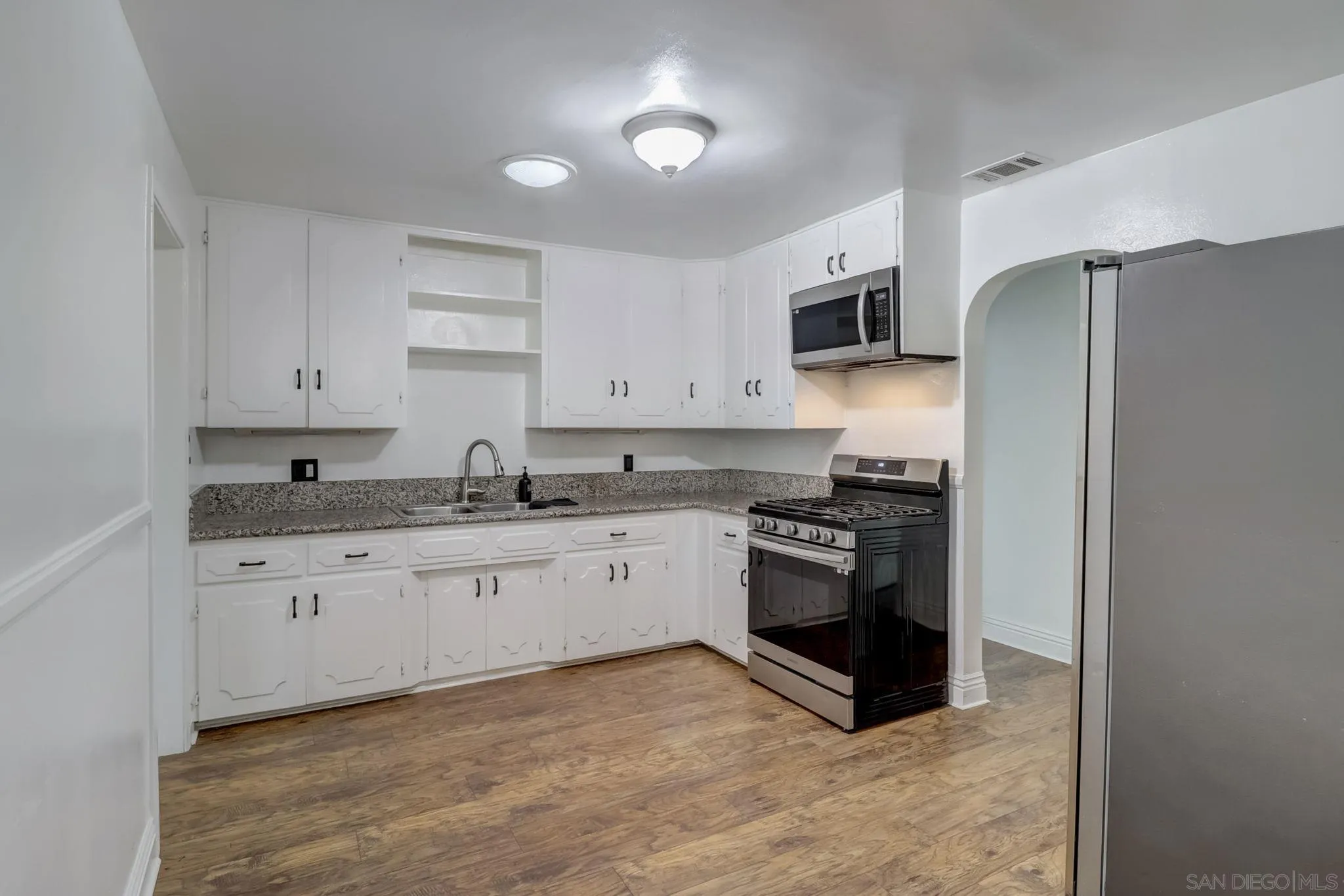 9115 Rosedale Drive Spring Valley, CA 91977 - Photo 15 of 31 a kitchen with stainless steel appliances granite countertop a refrigerator and a stove top oven