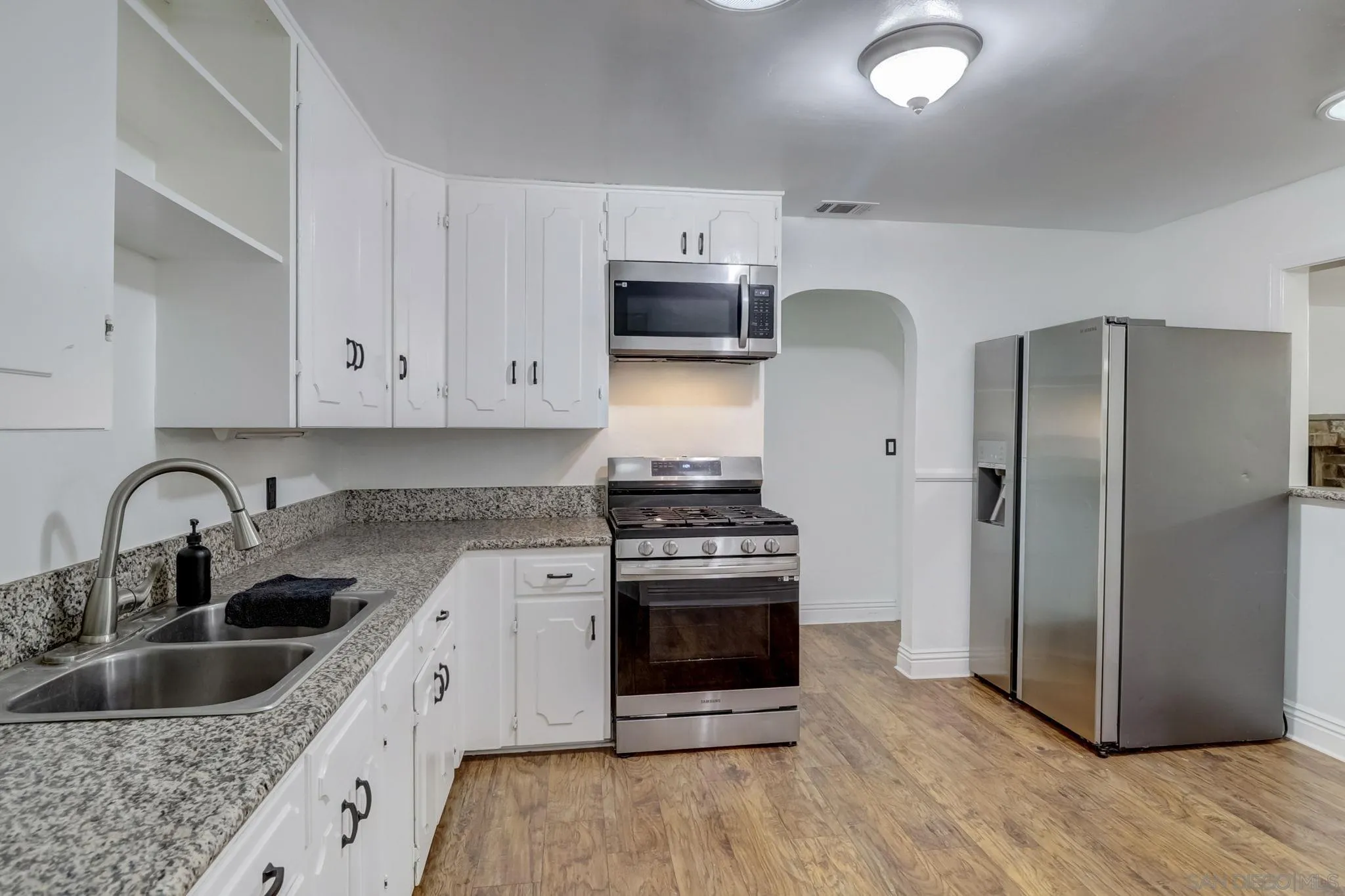 9115 Rosedale Drive Spring Valley, CA 91977 - Photo 16 of 31 a kitchen with stainless steel appliances granite countertop a stove a refrigerator and a sink