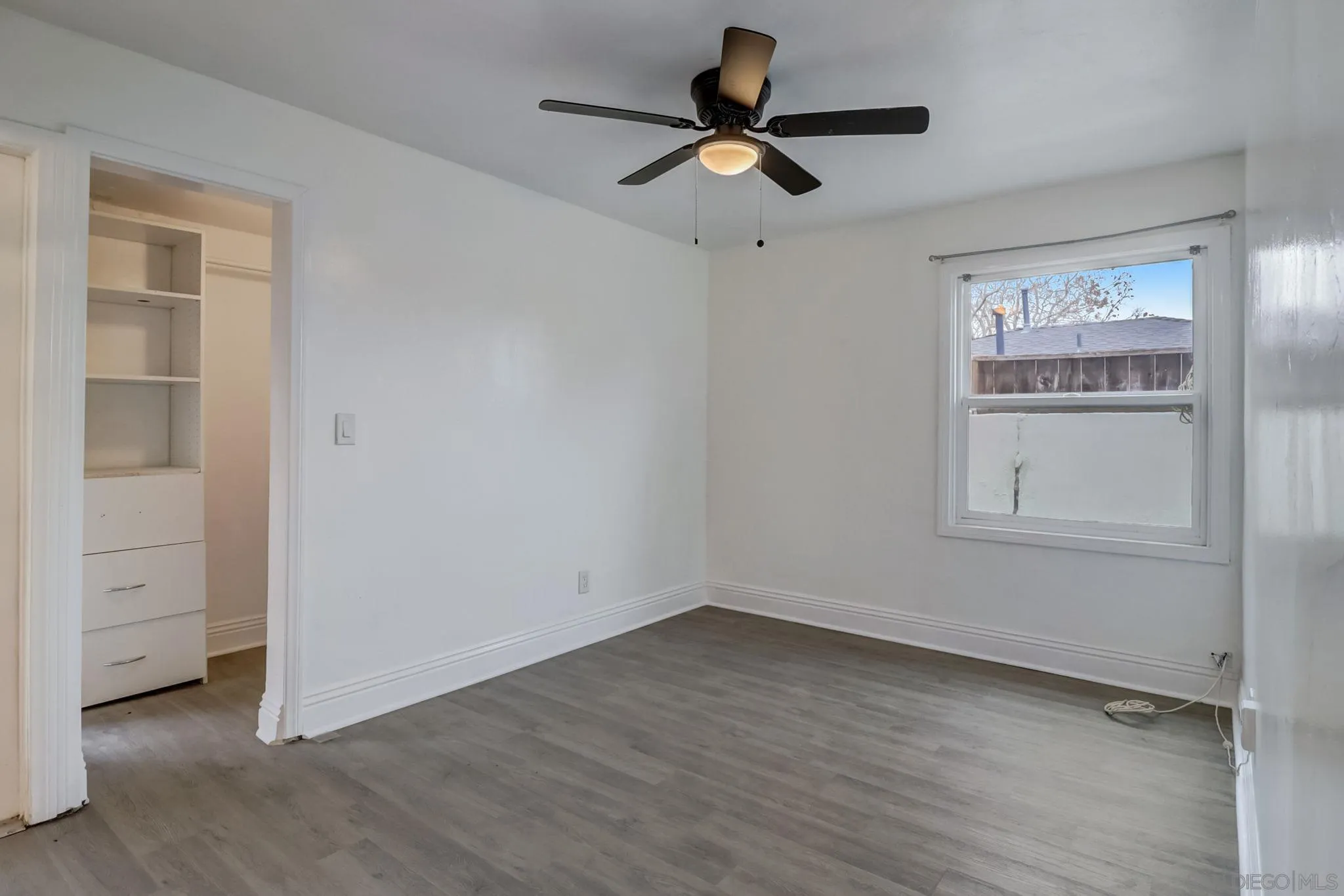 9115 Rosedale Drive Spring Valley, CA 91977 - Photo 21 of 31 an empty room with a window and a ceiling fan