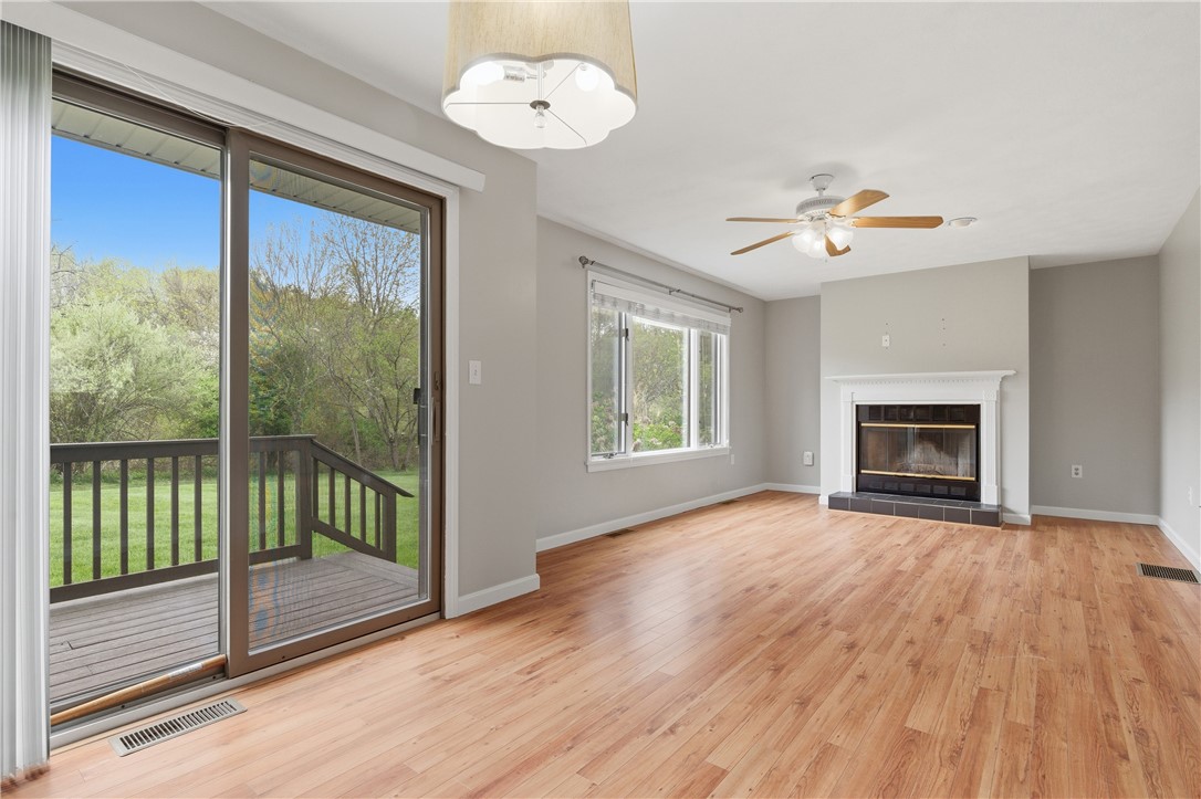 50 Abbott Run Valley Road, Unit 1604 Cumberland, RI 02864 - Photo 11 of 30 Living room with fireplace and entrance to deck