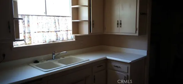 a kitchen with a refrigerator and a stove