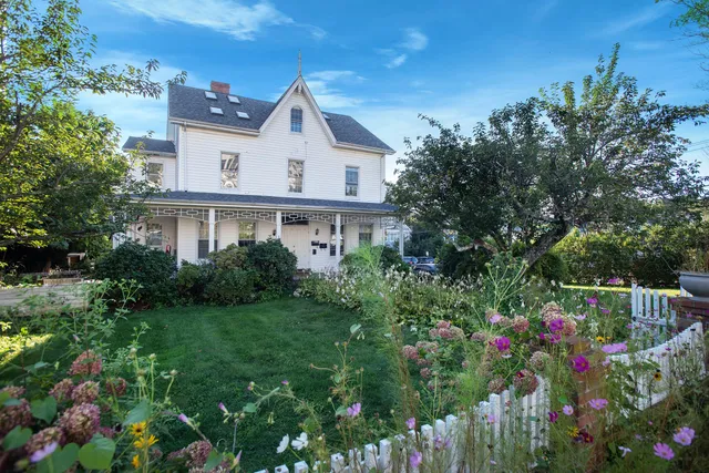 a view of a house with a yard and garden