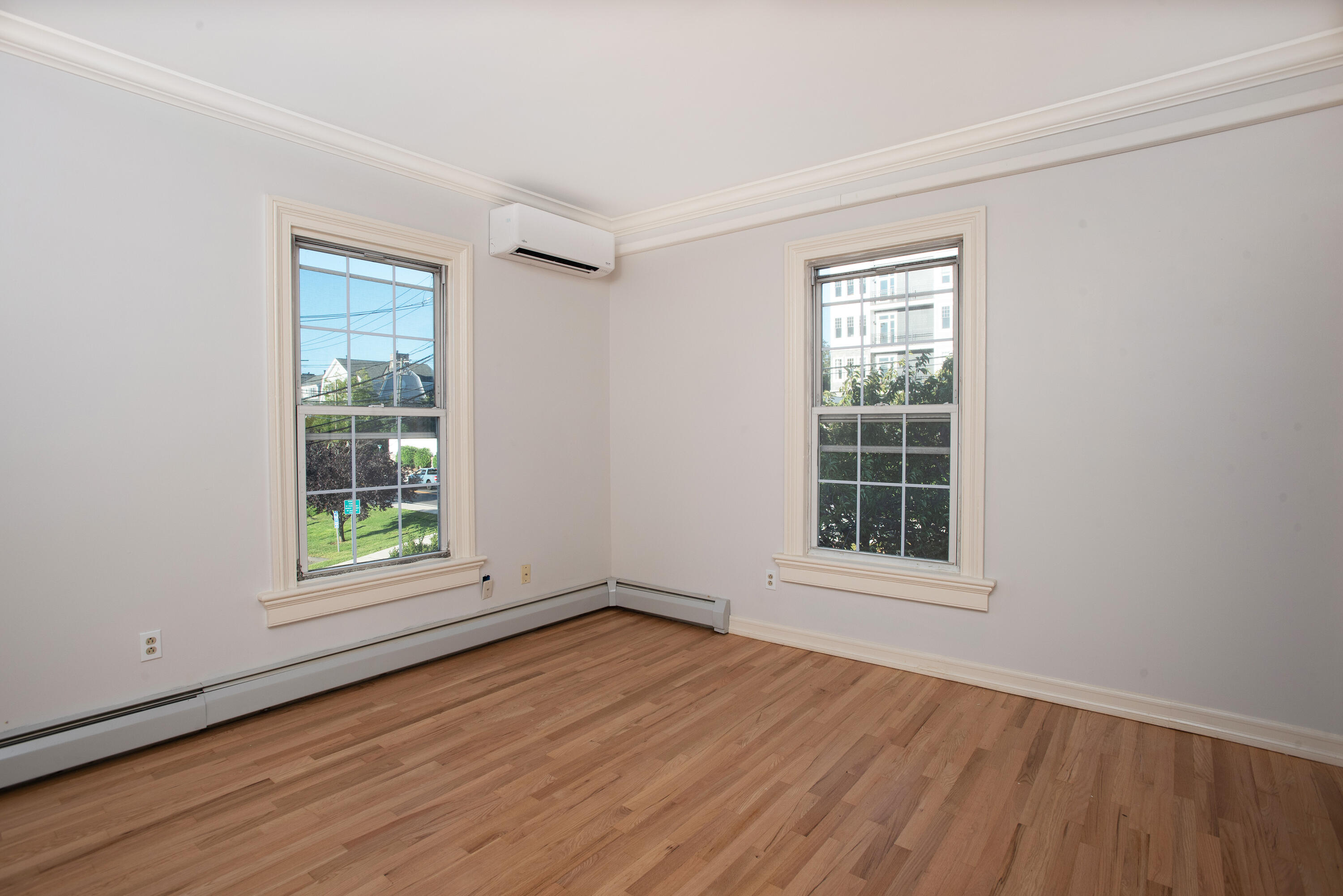 167 Park Street New Canaan, CT 06840 - Photo 11 of 18 an empty room with wooden floor and windows