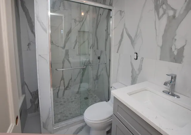 a bathroom with a sink toilet and shower