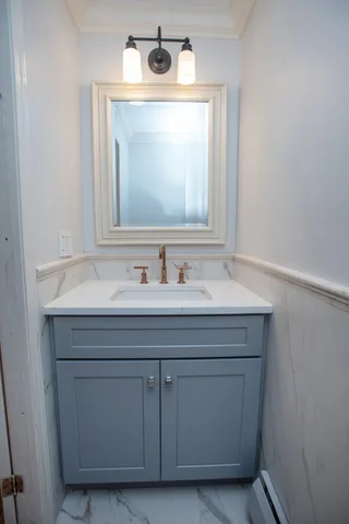 a bathroom with a sink vanity and mirror