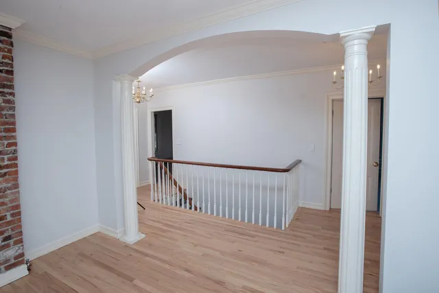 a view of hallway with wooden floor