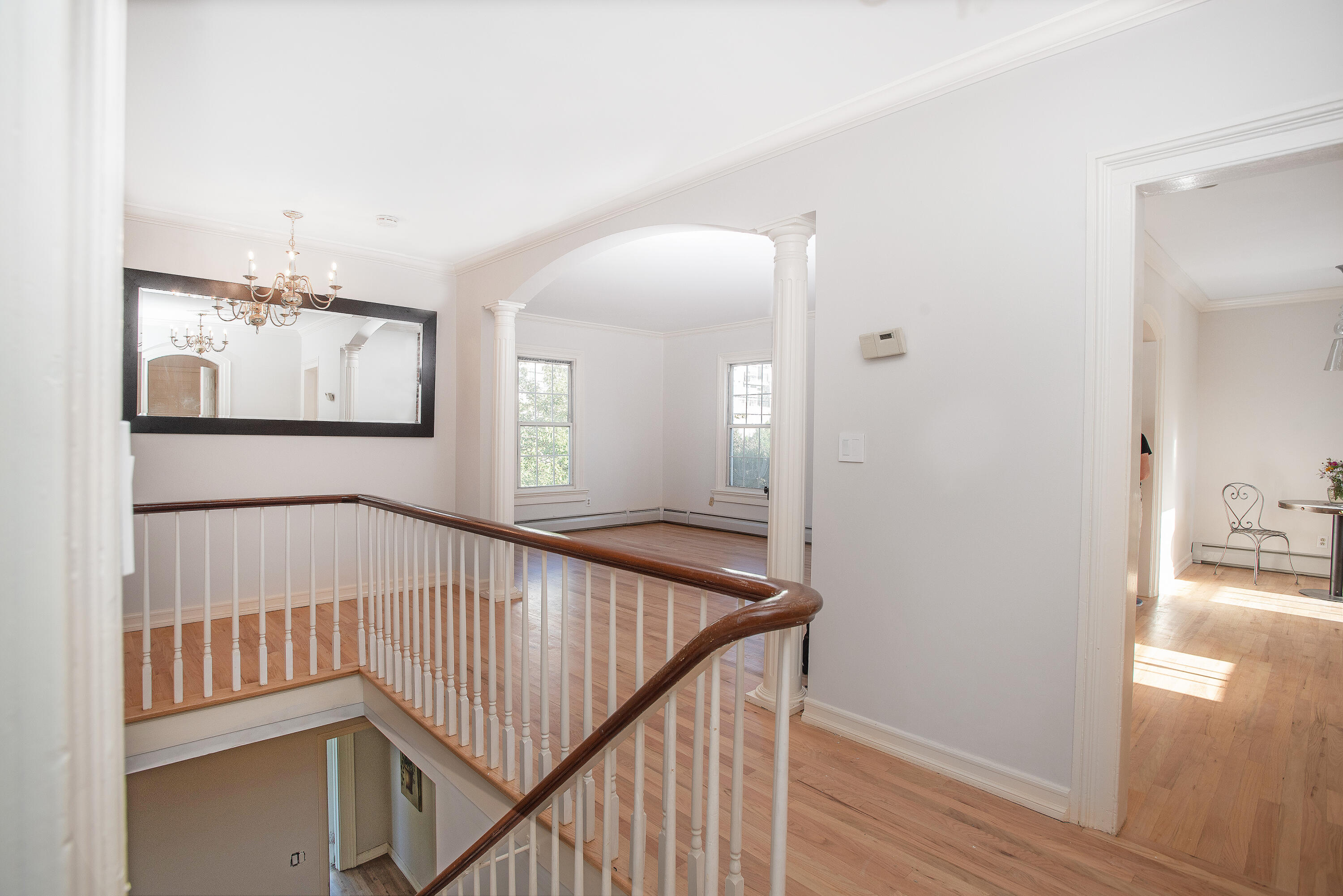 167 Park Street New Canaan, CT 06840 - Photo 5 of 18 a view of a hallway with wooden floor and staircase
