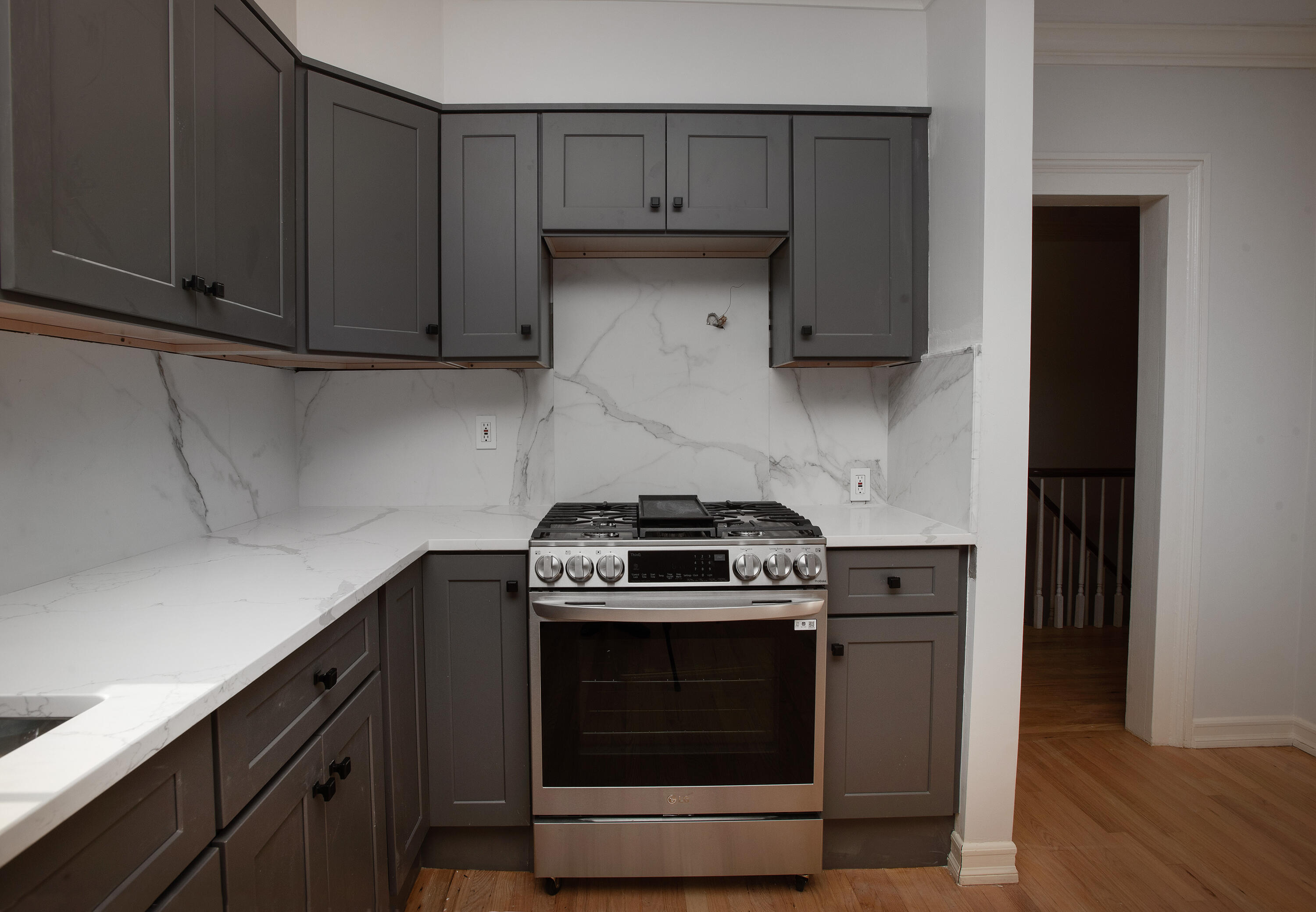 167 Park Street New Canaan, CT 06840 - Photo 8 of 18 a kitchen with wooden cabinets and a stove top oven