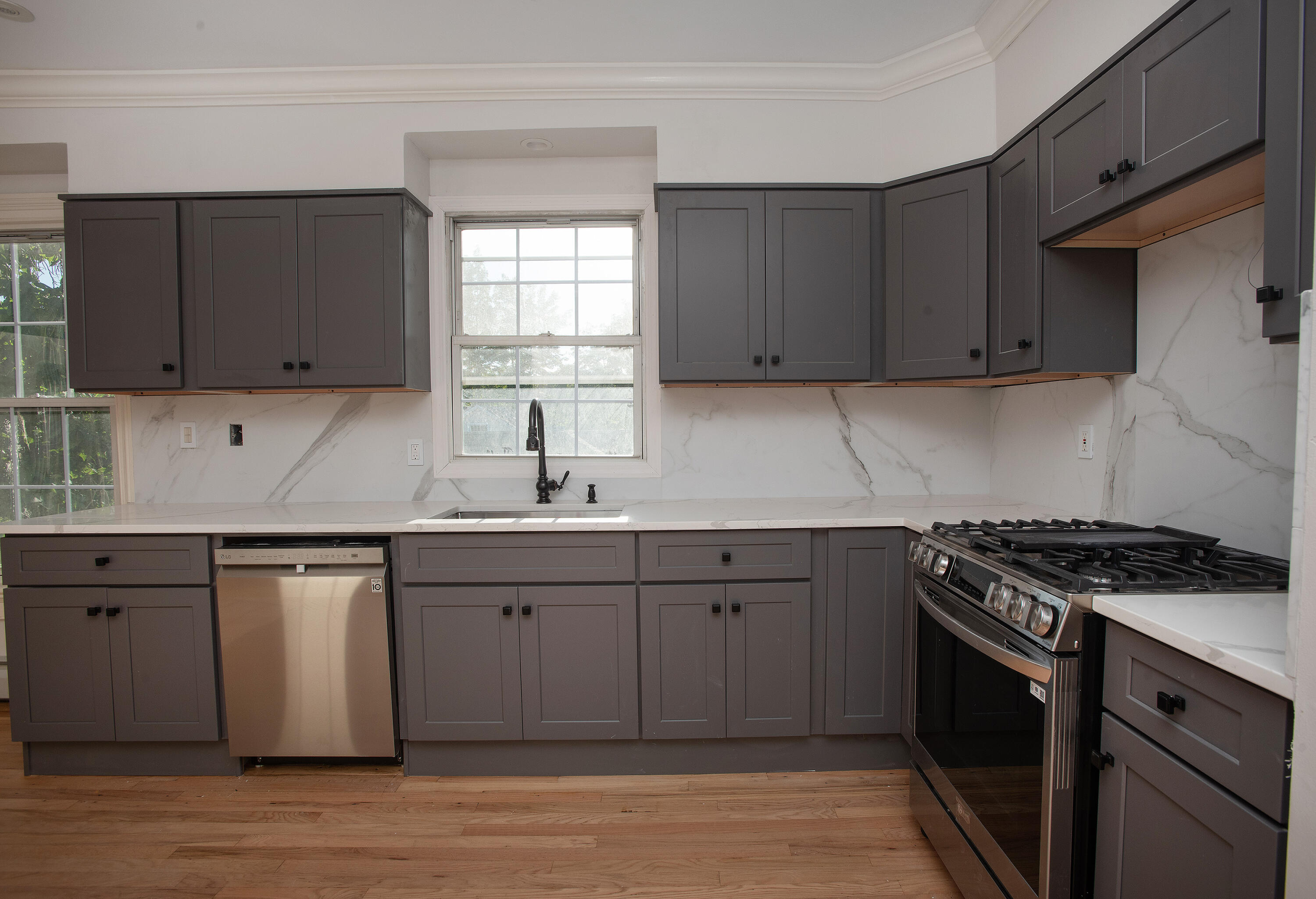 167 Park Street New Canaan, CT 06840 - Photo 9 of 18 a kitchen with granite countertop a sink cabinets and stainless steel appliances