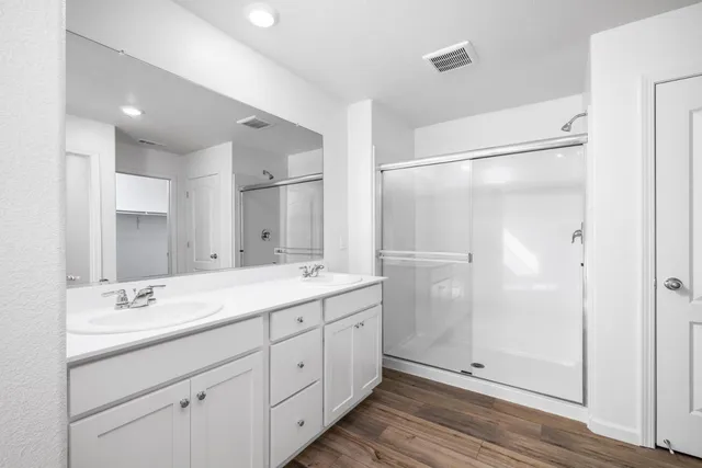 a spacious bathroom with a double vanity sink mirror and double