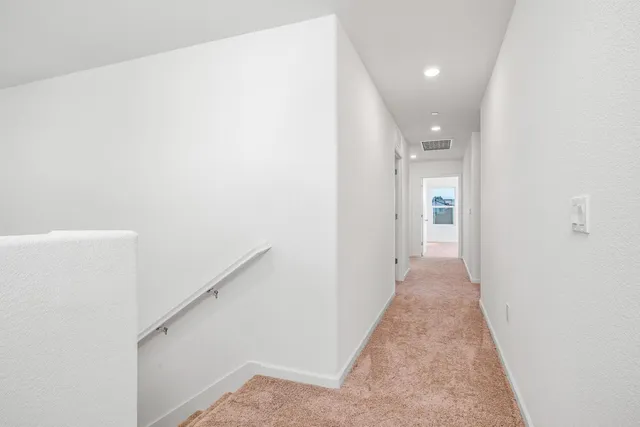 a view of a hallway with a white walls