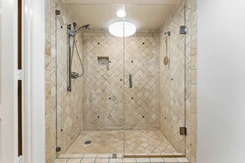 a large bedroom with a bed and a large window