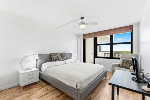 a bedroom with a bed and a large window